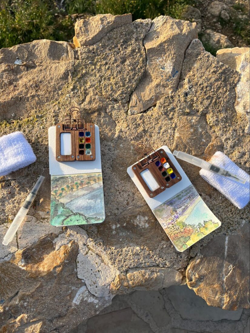 watercolor travel kit on rocks